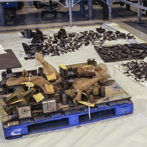 The fragments and components of the failed piston were collected and sent to a metallurgist to determine the failure mode. 

